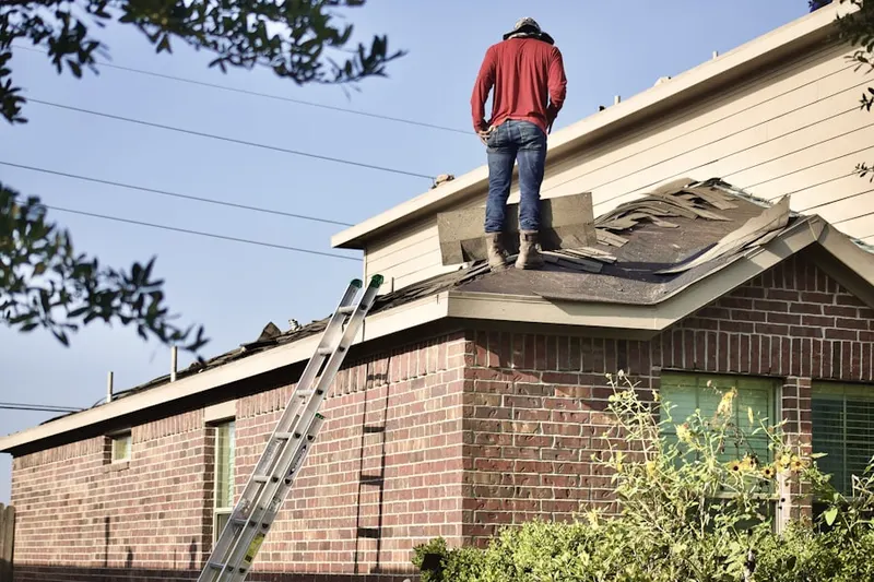 Professional roofer working on a residential roof in Wolf Hill
